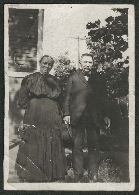 Man & wife outside house snapshot 1920s