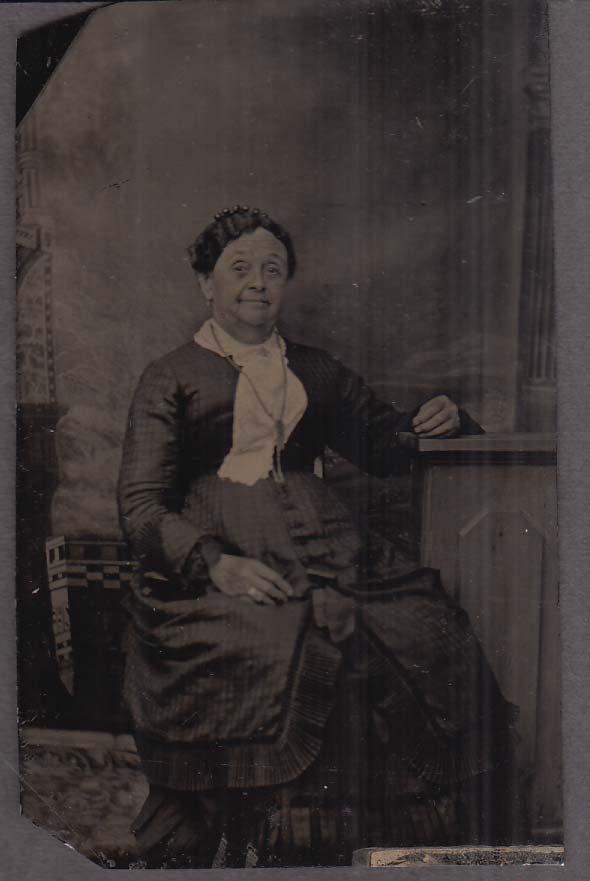 Stout elderly women with necklace faint smile studio tintype 1860s