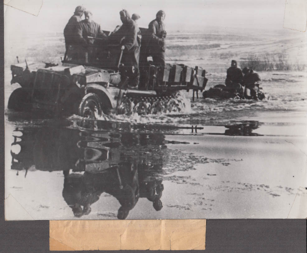 German halftrack tows vehicle from river World War II Romanian news photo